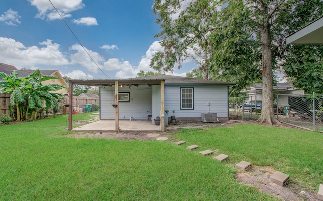 back of property featuring a lawn, a patio, and cooling unit