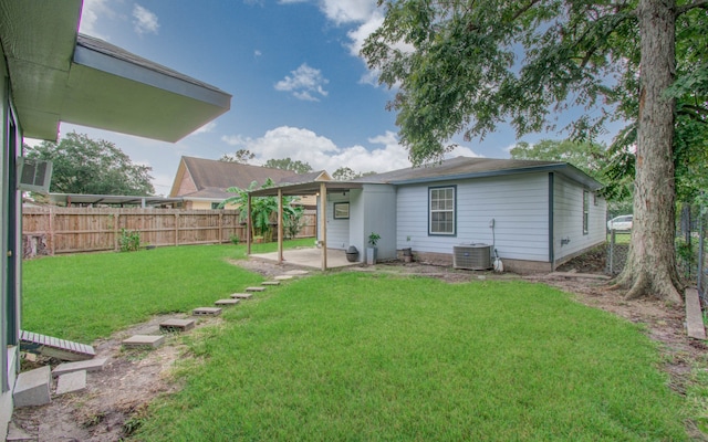 back of property with a lawn, a patio area, and central AC