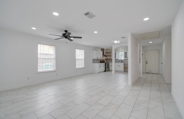 unfurnished living room with ceiling fan