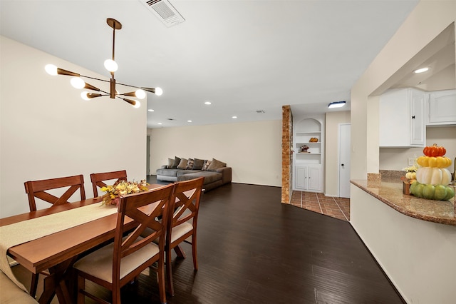 dining area with an inviting chandelier and hardwood / wood-style flooring