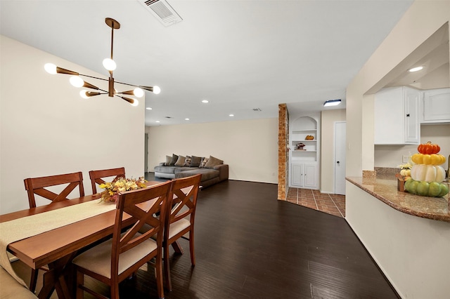 dining space featuring recessed lighting, a notable chandelier, wood finished floors, and visible vents