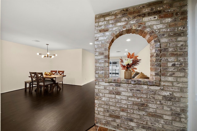 dining area featuring an inviting chandelier and dark hardwood / wood-style flooring