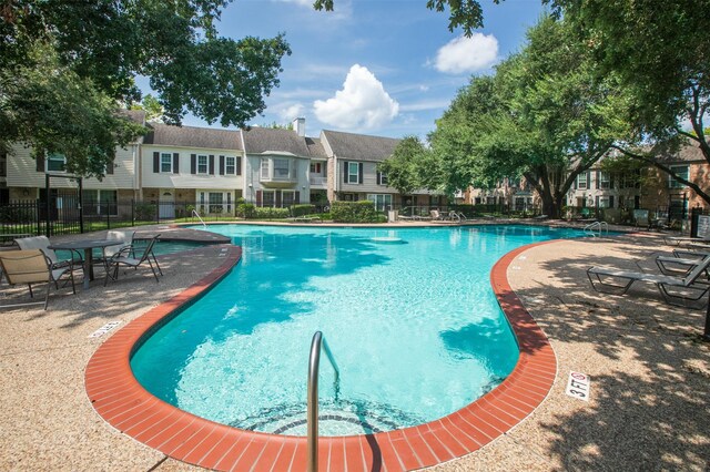 view of swimming pool with a patio