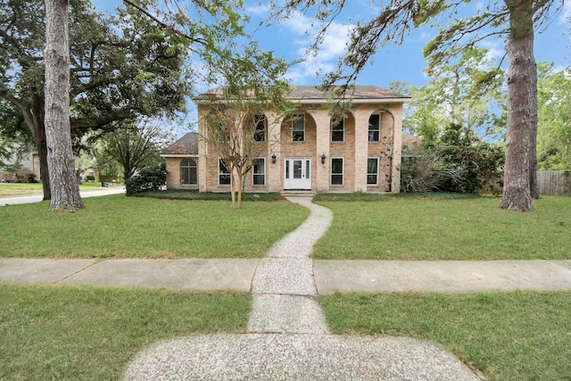 mediterranean / spanish-style home with a front yard