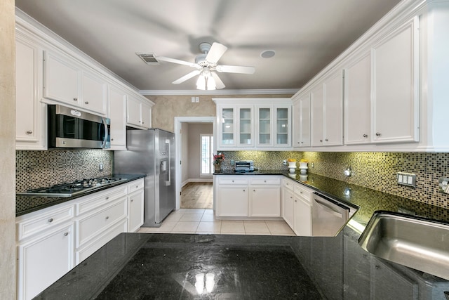 kitchen with white cabinets, ceiling fan, stainless steel appliances, and ornamental molding