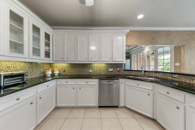 kitchen with white cabinets, dark stone countertops, sink, and stainless steel dishwasher