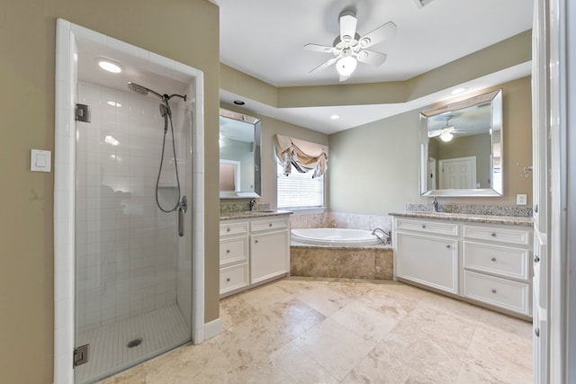 bathroom with vanity, ceiling fan, and plus walk in shower