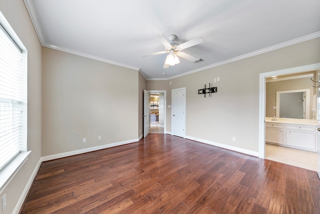 empty room featuring ceiling fan, hardwood / wood-style flooring, and crown molding