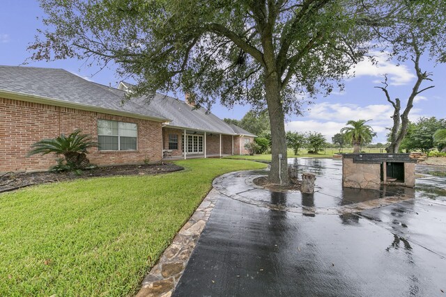 exterior space with a patio area and a front lawn