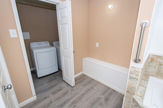 2620 W Shane St, Alvin, TX 77511 - washroom with wood finished floors and washing machine and dryer