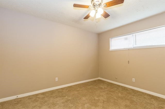 carpeted empty room featuring ceiling fan and a textured ceiling