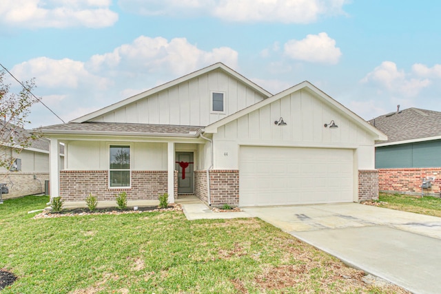 view of front of home featuring covered porch, a garage, and a front lawn