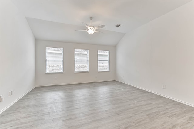 unfurnished room with lofted ceiling, ceiling fan, and light hardwood / wood-style floors