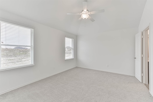 interior space featuring lofted ceiling, ceiling fan, and light carpet