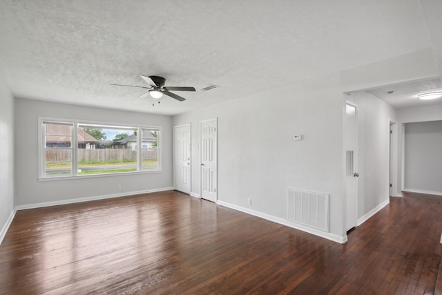 spare room with a textured ceiling, ceiling fan, and dark hardwood / wood-style floors