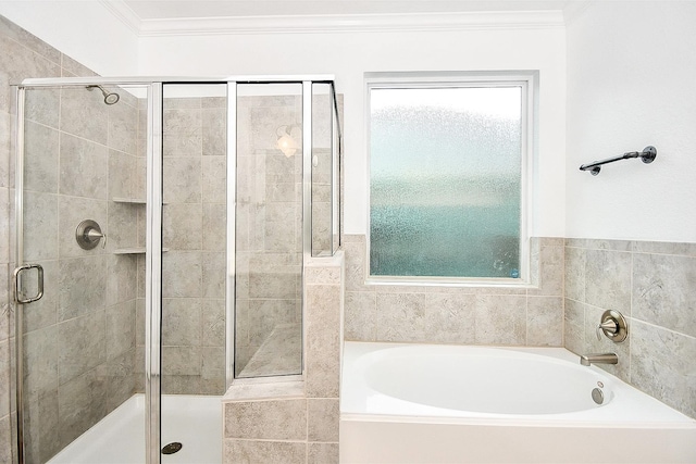 bathroom with plus walk in shower, a wealth of natural light, and ornamental molding