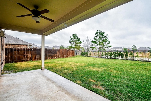 view of yard featuring ceiling fan and a patio