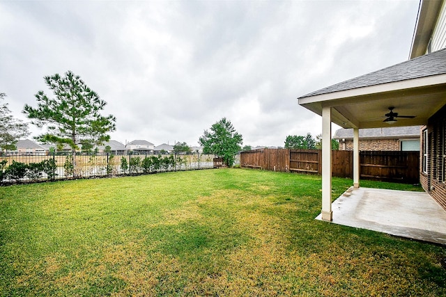 view of yard featuring ceiling fan and a patio