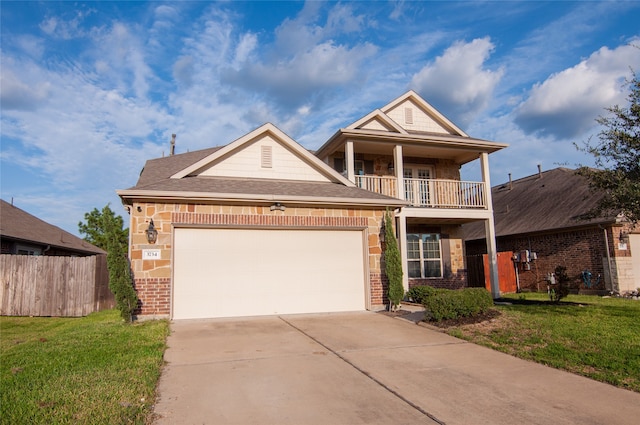 view of front of house with a balcony and a front yard