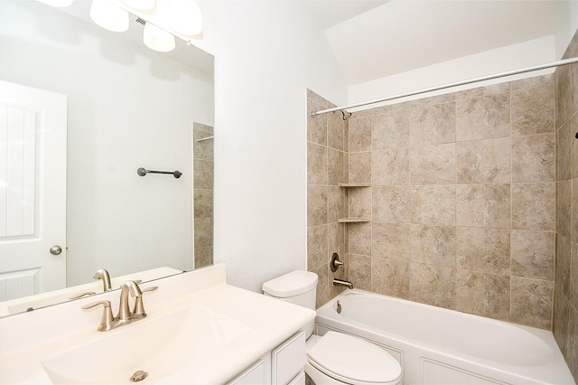 full bathroom with tiled shower / bath, vanity, toilet, and lofted ceiling