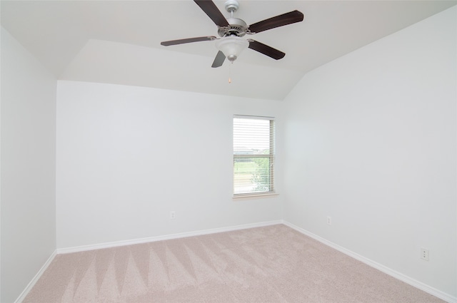 carpeted spare room featuring lofted ceiling and ceiling fan