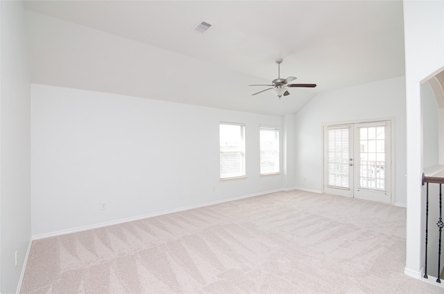 carpeted spare room featuring lofted ceiling and ceiling fan