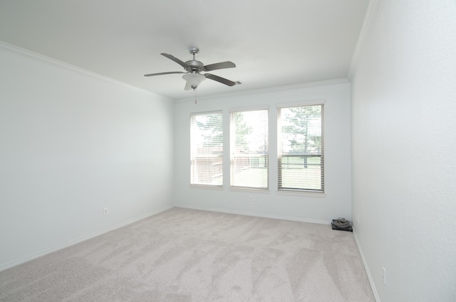 unfurnished room featuring ornamental molding, light colored carpet, and ceiling fan