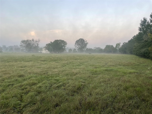 nature at dusk featuring a rural view