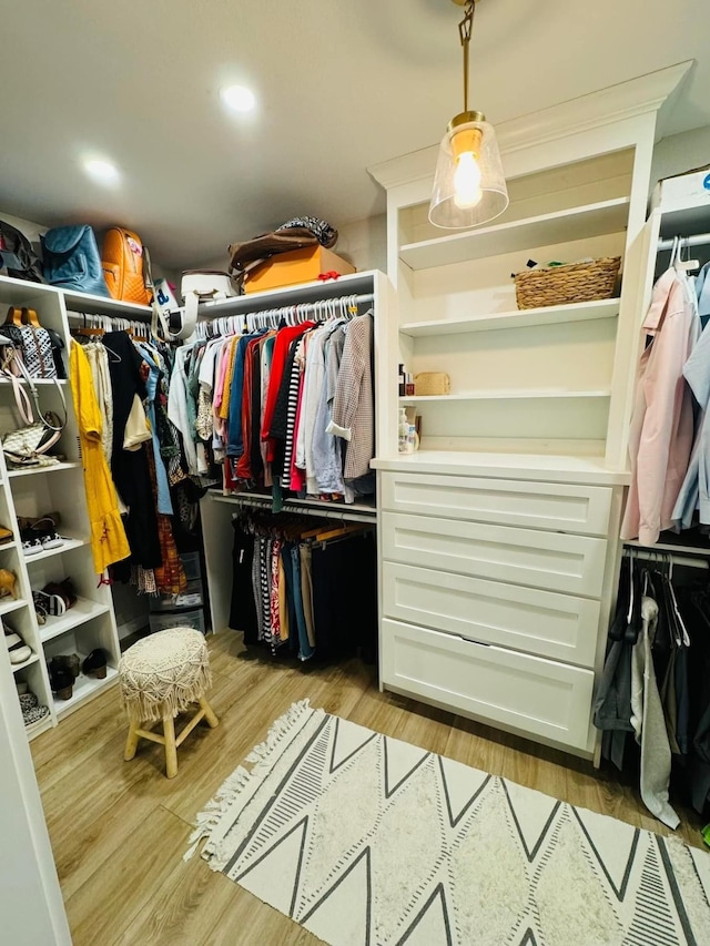 spacious closet featuring light hardwood / wood-style floors