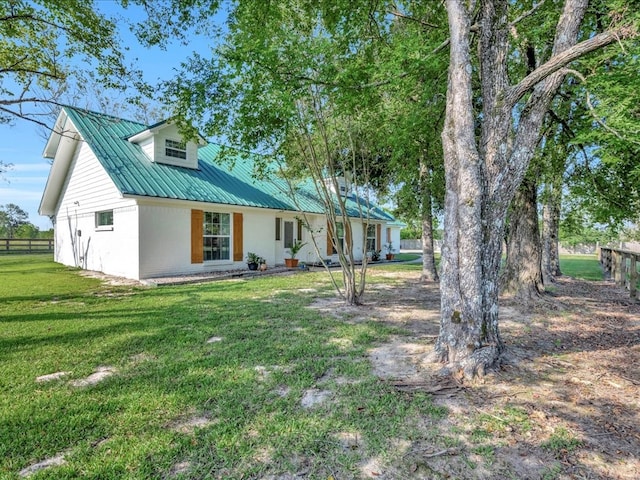 rear view of property with a lawn