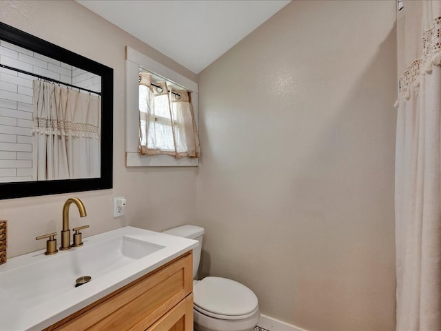 bathroom featuring walk in shower, vanity, toilet, and vaulted ceiling