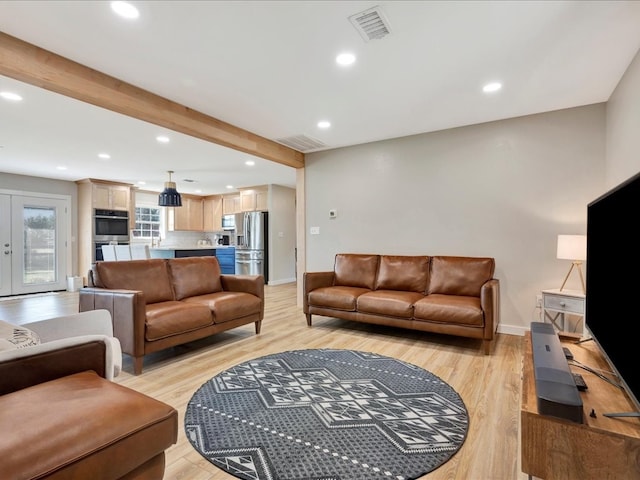 living room featuring french doors, light hardwood / wood-style flooring, and beam ceiling