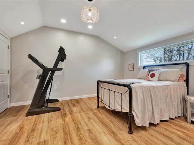 bedroom featuring light hardwood / wood-style flooring and lofted ceiling