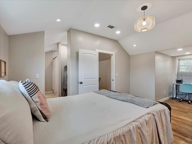 bedroom featuring light wood-type flooring and lofted ceiling