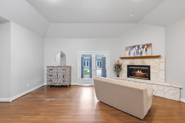 living room with a fireplace, french doors, dark hardwood / wood-style flooring, and lofted ceiling