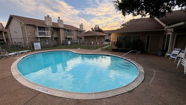 view of pool at dusk