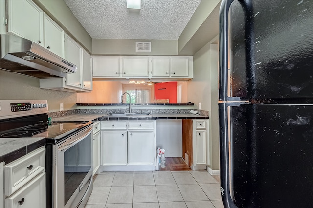 kitchen with white cabinetry, appliances with stainless steel finishes, light tile patterned flooring, and sink