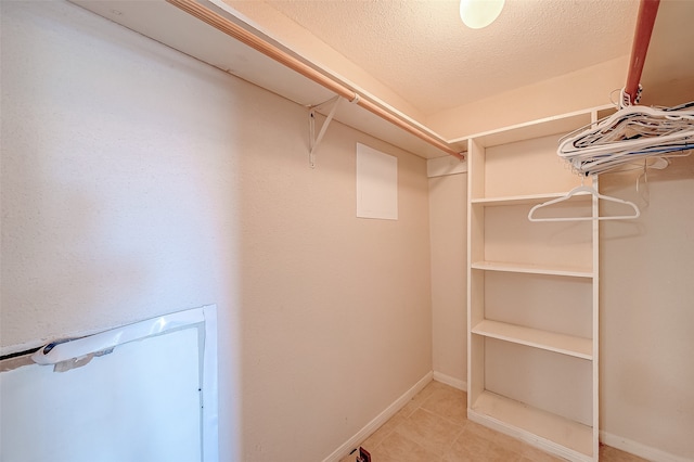 spacious closet with light tile patterned floors