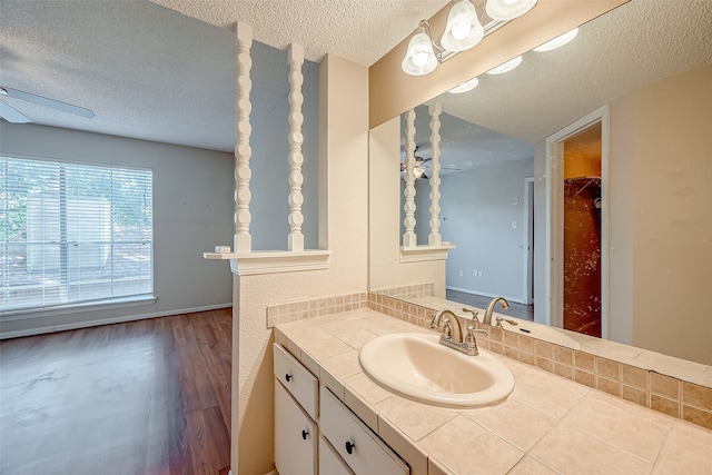 bathroom featuring a textured ceiling, vanity, hardwood / wood-style floors, and ceiling fan