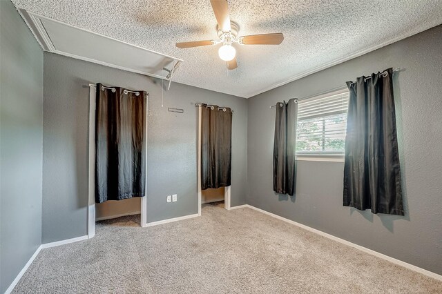 1505 Ward Rd Unit 214, Baytown, TX 77520 - unfurnished bedroom with attic access, baseboards, carpet floors, and a textured ceiling