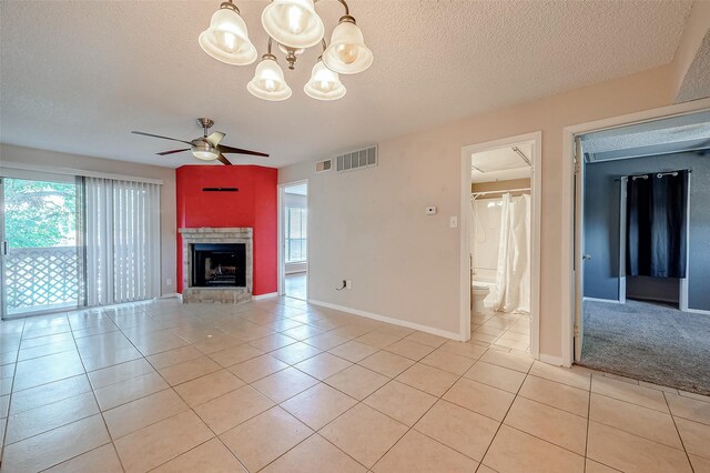 1505 Ward Rd Unit 214, Baytown, TX 77520 - unfurnished living room featuring light tile patterned flooring, ceiling fan with notable chandelier, a textured ceiling, and visible vents