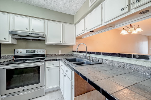 kitchen featuring sink, white cabinetry, an inviting chandelier, tile countertops, and stainless steel electric range