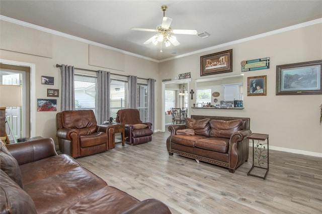 living room featuring crown molding, ceiling fan, and light wood-type flooring