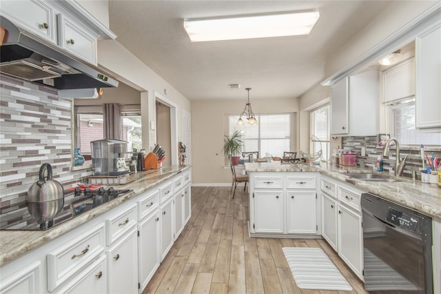 kitchen with a healthy amount of sunlight, black appliances, white cabinetry, and sink