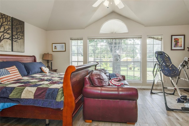 bedroom with lofted ceiling, multiple windows, ceiling fan, and hardwood / wood-style floors