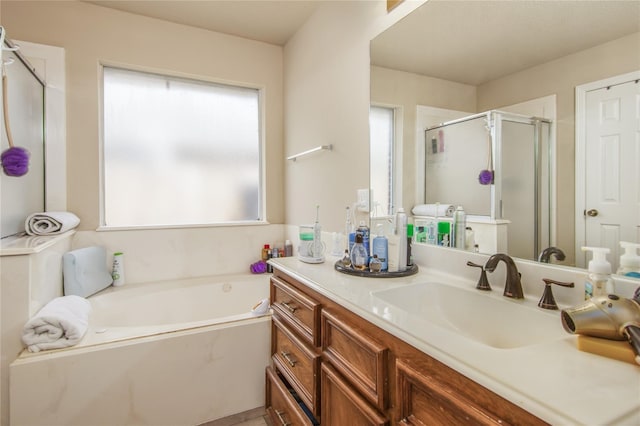 bathroom featuring shower with separate bathtub and vanity