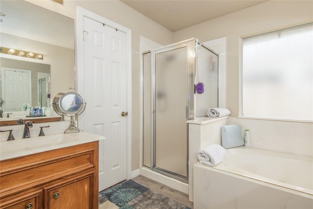 bathroom with vanity, hardwood / wood-style floors, and independent shower and bath