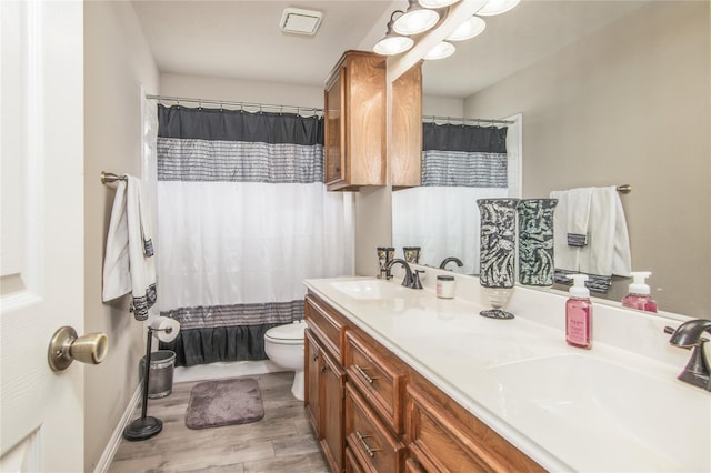 bathroom with vanity, toilet, a shower with curtain, and hardwood / wood-style floors