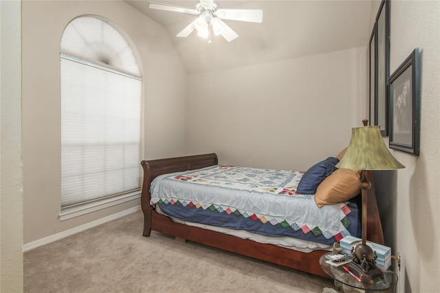 carpeted bedroom with vaulted ceiling and ceiling fan