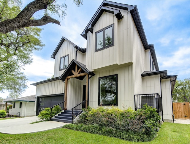 modern farmhouse style home featuring a garage and a front lawn